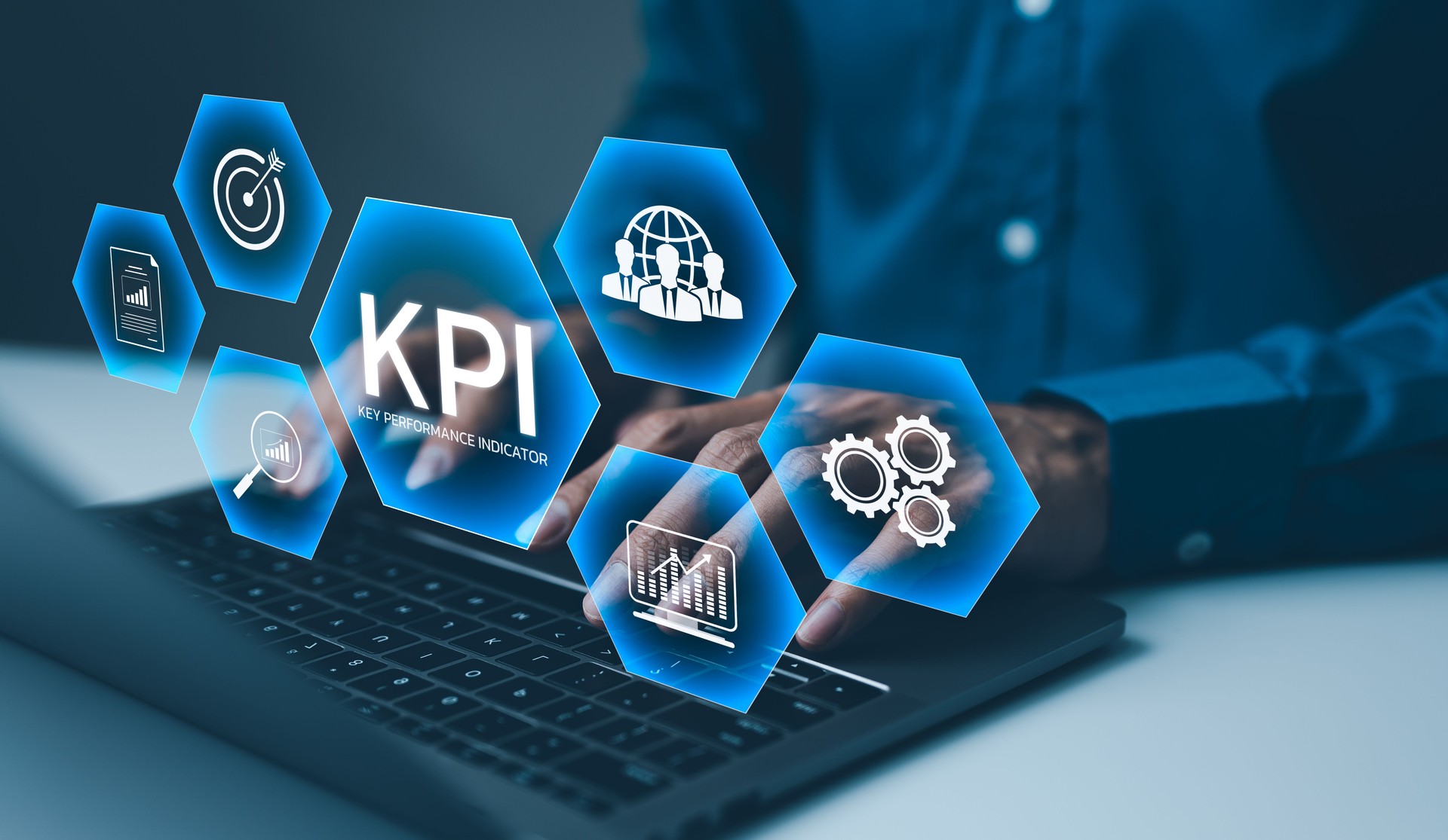 KPI, Analyzing Key Performance Indicators. Businessman using laptop to analyze key performance indicators (KPIs) displayed as holographic icons, representing business metrics, and performance analysis